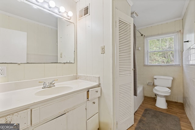 full bathroom with toilet, vanity, wood-type flooring, and ornamental molding