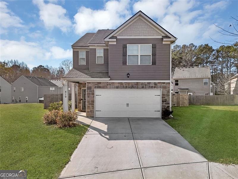 view of front of home with a front lawn and a garage