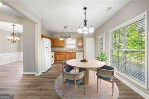 dining room with dark hardwood / wood-style floors and a notable chandelier