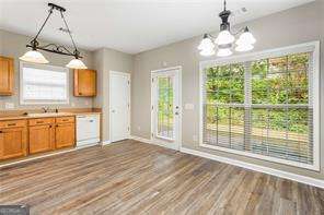 kitchen with a chandelier, plenty of natural light, hanging light fixtures, and dishwasher