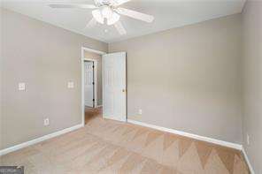 unfurnished room featuring carpet flooring and ceiling fan