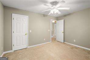 unfurnished bedroom featuring light colored carpet and ceiling fan