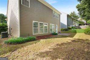 view of property exterior featuring a lawn and central AC unit