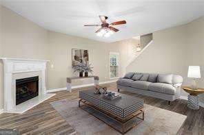 living room featuring ceiling fan and dark hardwood / wood-style flooring