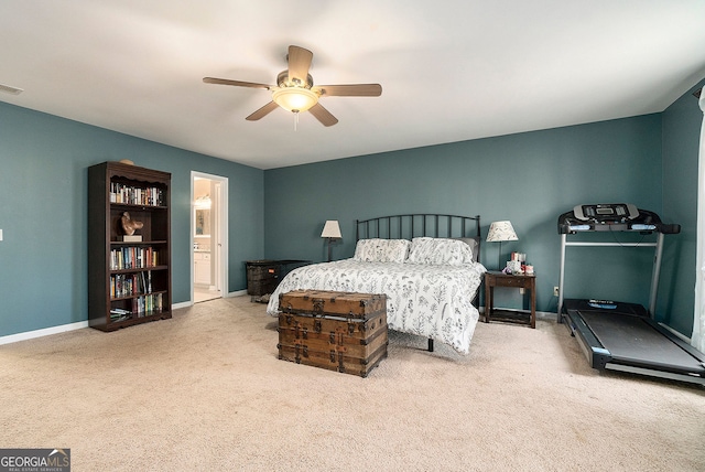 carpeted bedroom featuring ceiling fan and ensuite bathroom