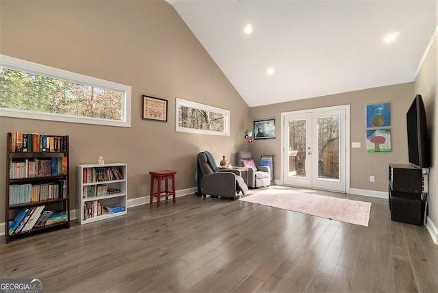 living area with high vaulted ceiling, french doors, and dark hardwood / wood-style floors