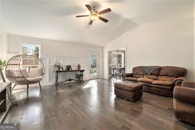 living room with ceiling fan, dark wood-type flooring, and vaulted ceiling