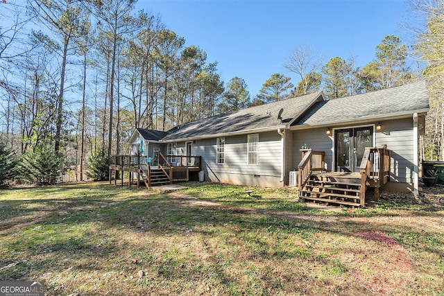 back of house with french doors, a yard, and a wooden deck