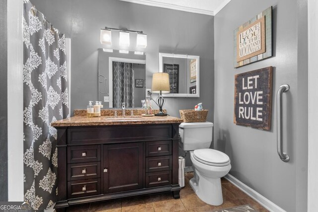 bathroom featuring walk in shower, tile patterned flooring, toilet, vanity, and ornamental molding