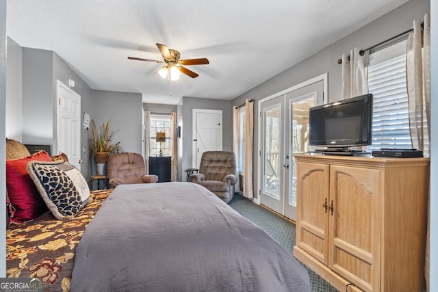 carpeted bedroom with access to exterior, french doors, a textured ceiling, and ceiling fan