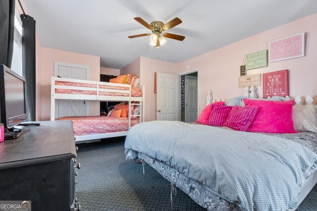 bedroom with dark colored carpet and ceiling fan