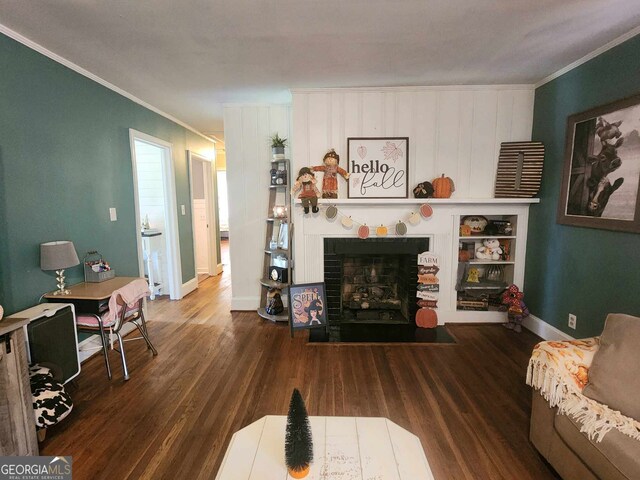 living room with a fireplace, dark hardwood / wood-style flooring, and ornamental molding