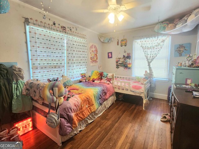 bedroom with ceiling fan, crown molding, and dark hardwood / wood-style floors