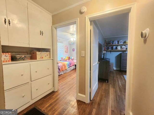 hall with dark hardwood / wood-style floors and ornamental molding