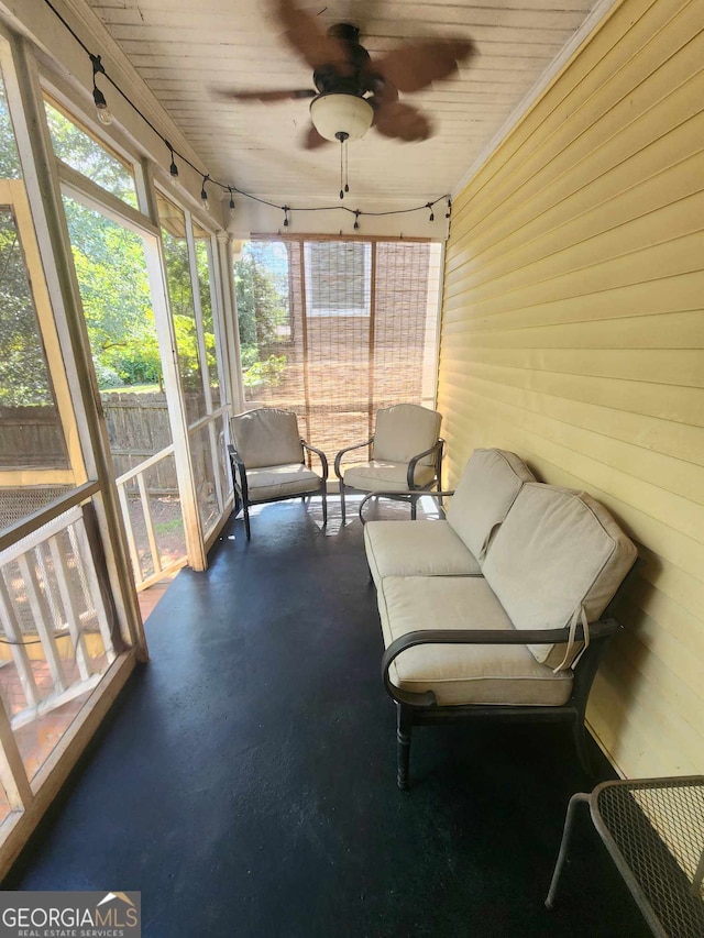 sunroom / solarium featuring ceiling fan and wood ceiling