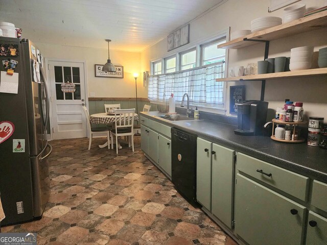 kitchen with green cabinets, stainless steel fridge, sink, and black dishwasher