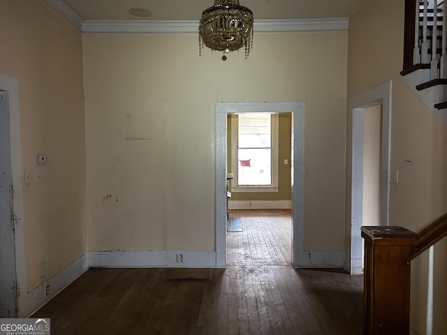 interior space featuring a notable chandelier, dark hardwood / wood-style flooring, and crown molding