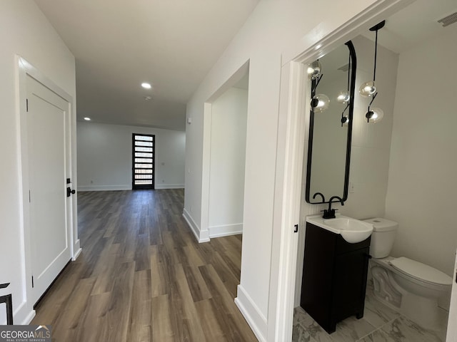 corridor with sink and dark hardwood / wood-style flooring