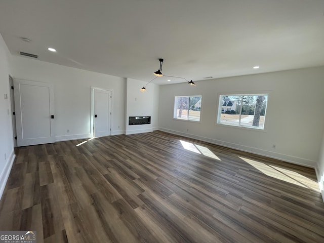 unfurnished living room with dark hardwood / wood-style floors