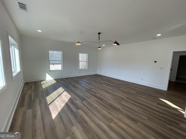 unfurnished living room featuring dark wood-type flooring