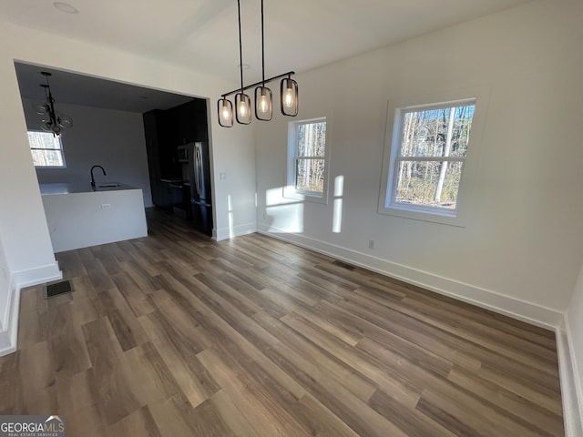 unfurnished dining area with sink and dark hardwood / wood-style flooring