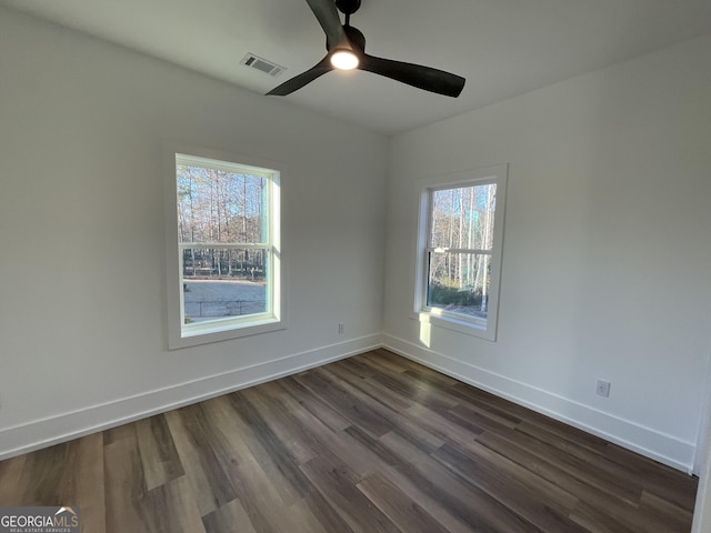 empty room with dark hardwood / wood-style flooring and ceiling fan