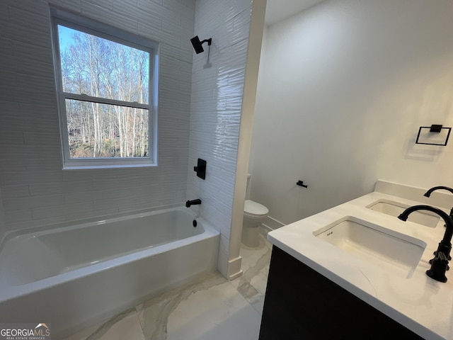 full bathroom with tiled shower / bath combo, vanity, and toilet