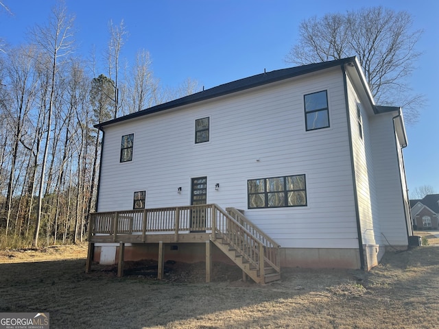 back of house with a deck