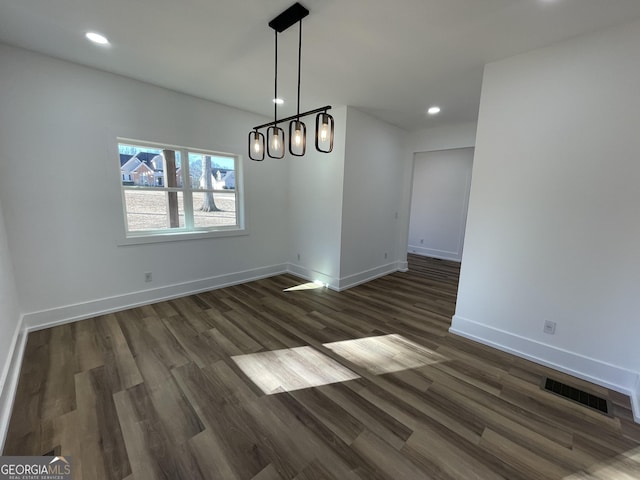 unfurnished dining area with dark hardwood / wood-style flooring