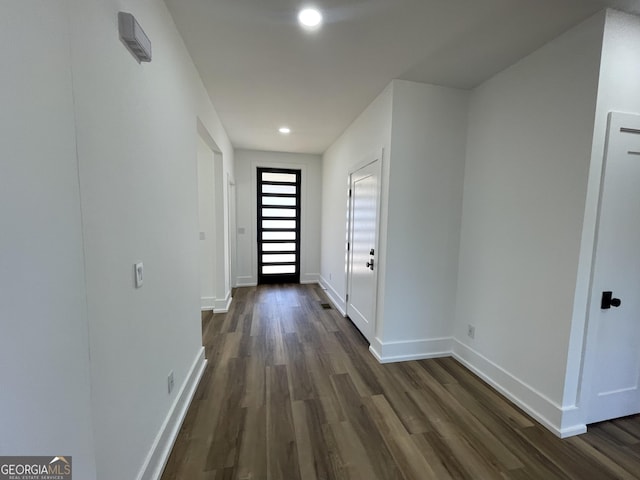 doorway to outside with dark wood-type flooring