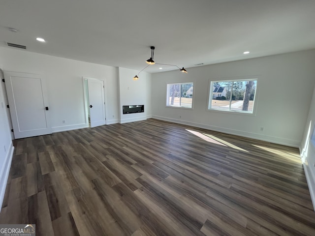 unfurnished living room featuring dark wood-type flooring