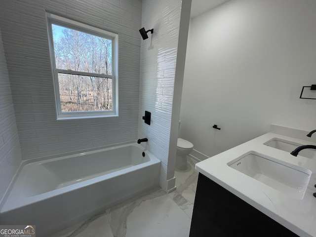 full bathroom featuring vanity, tiled shower / bath combo, and toilet