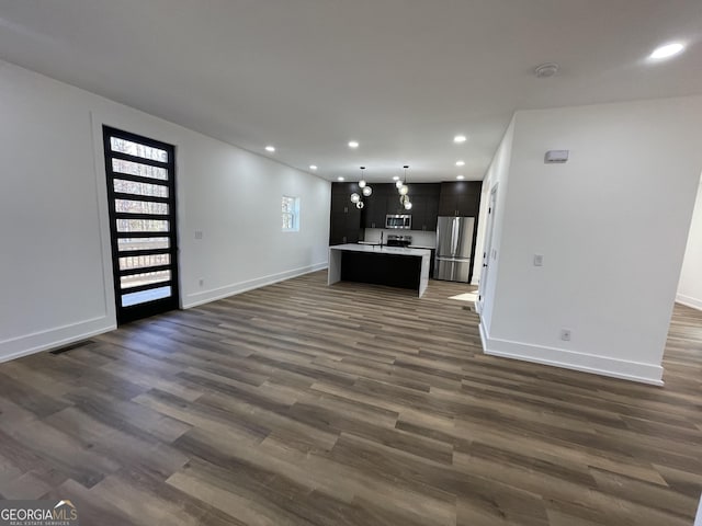 unfurnished living room featuring dark hardwood / wood-style flooring