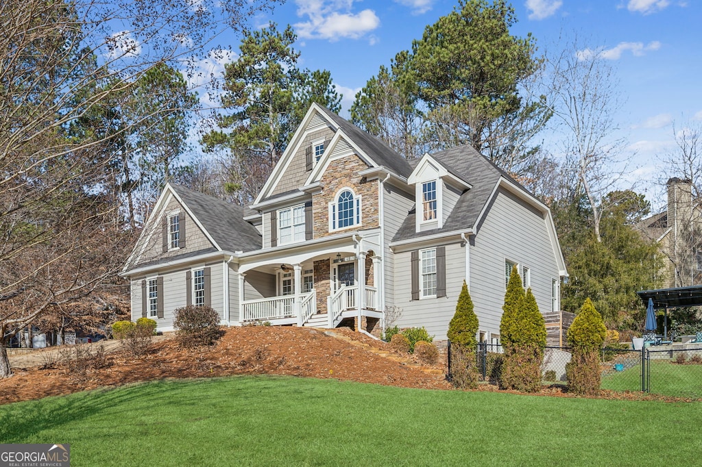 front facade featuring a porch and a front yard