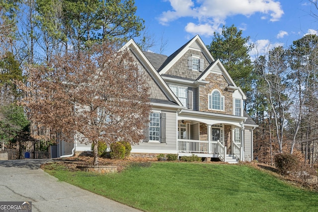 view of front of home with a front yard and covered porch