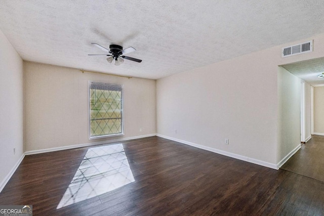 empty room with a textured ceiling, ceiling fan, and dark wood-type flooring