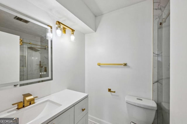 bathroom featuring vanity, toilet, and an enclosed shower