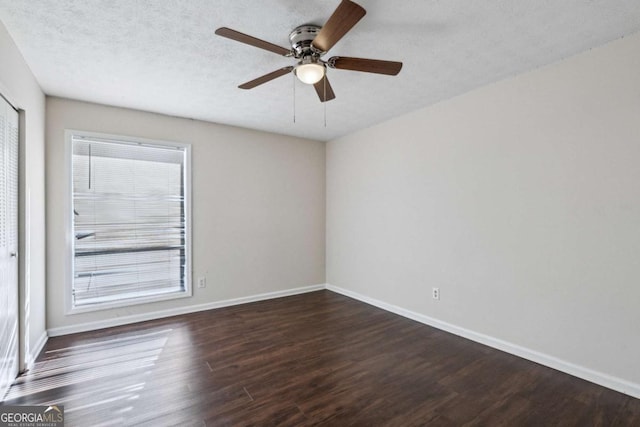 spare room featuring a textured ceiling, dark hardwood / wood-style floors, and ceiling fan