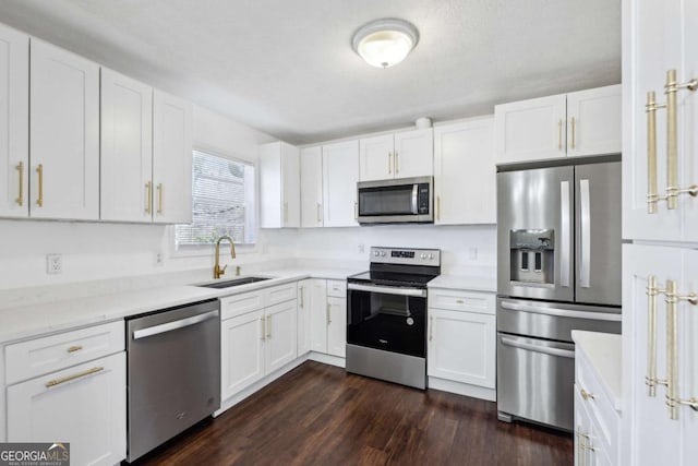 kitchen featuring dark hardwood / wood-style flooring, sink, white cabinets, and appliances with stainless steel finishes