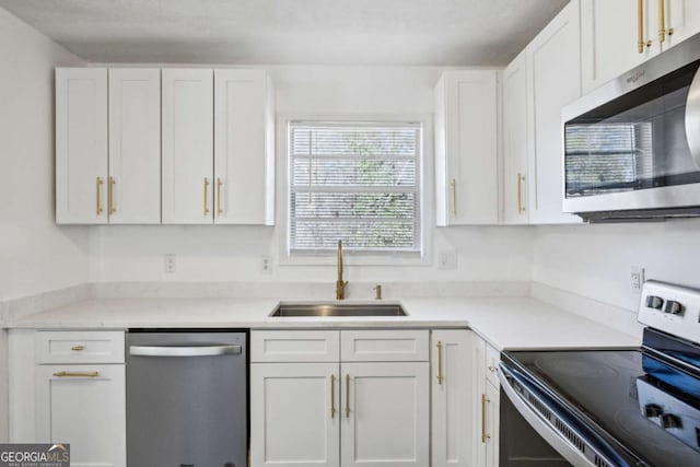 kitchen with white cabinetry, sink, and appliances with stainless steel finishes