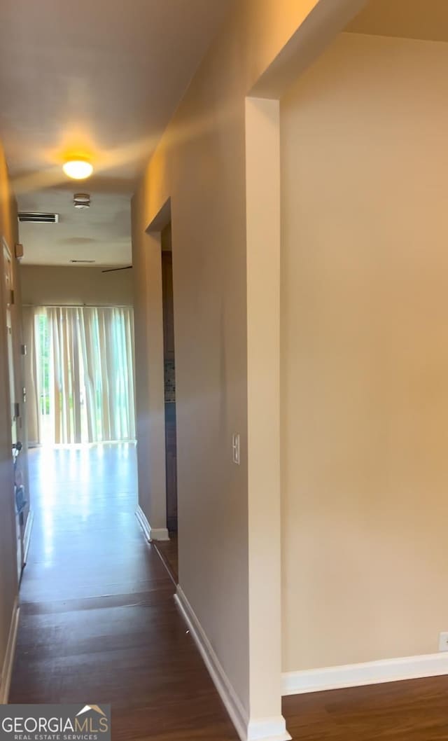 hallway with dark wood-type flooring