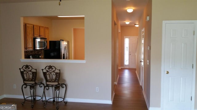 kitchen with dark hardwood / wood-style flooring and appliances with stainless steel finishes