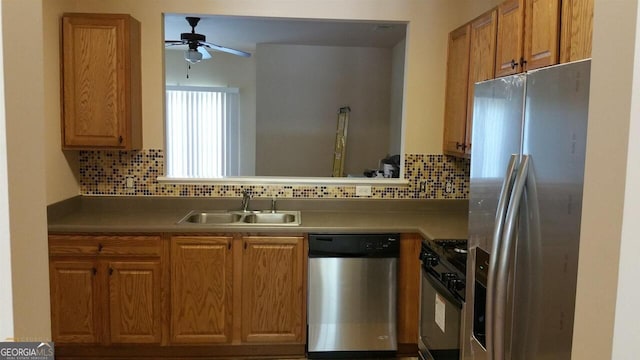 kitchen featuring decorative backsplash, appliances with stainless steel finishes, ceiling fan, and sink