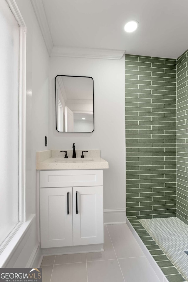 bathroom with a shower, vanity, tile patterned floors, and ornamental molding