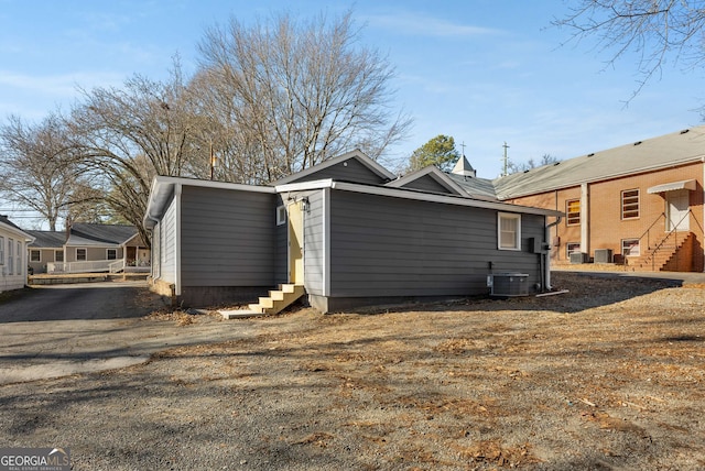 view of side of home featuring cooling unit