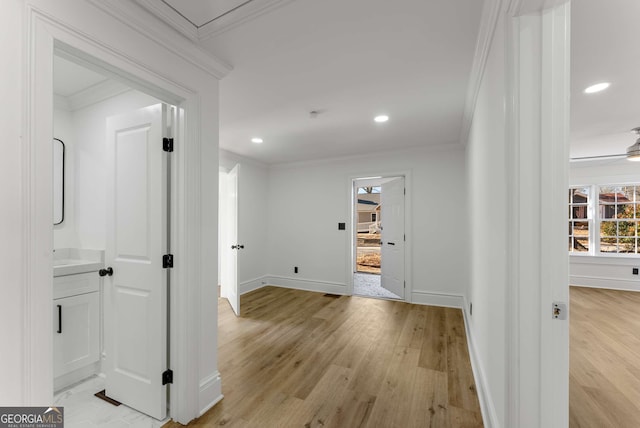 hall featuring light hardwood / wood-style floors and crown molding