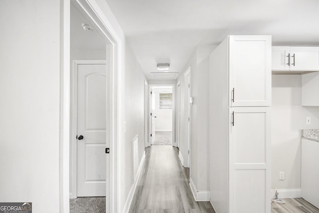 corridor featuring light hardwood / wood-style floors