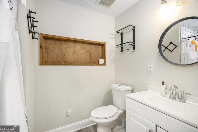 bathroom featuring vanity and toilet