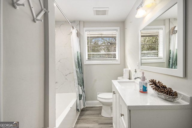 full bathroom featuring wood-type flooring, vanity, toilet, and shower / bath combo with shower curtain