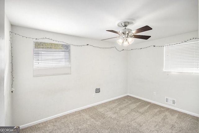 unfurnished room featuring ceiling fan and carpet